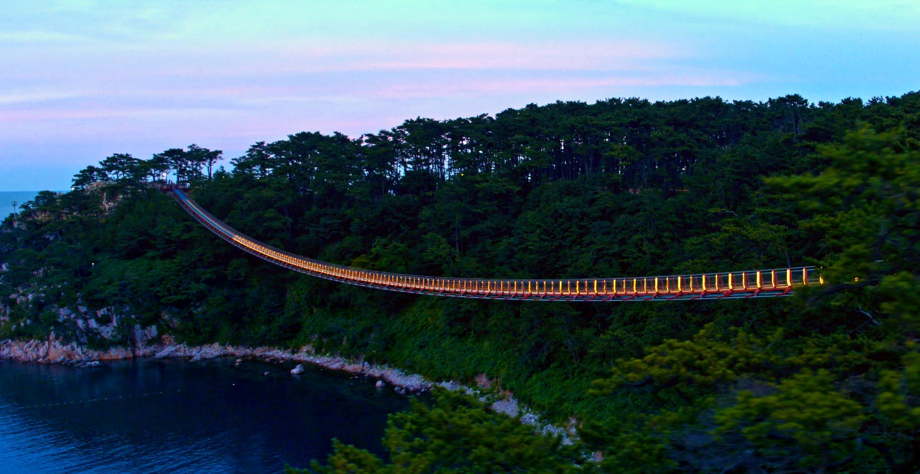 LED strip on suspension bridge over water